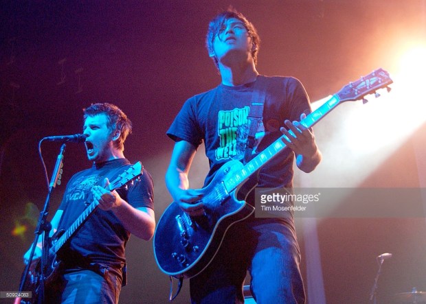 SAN JOSE, CA - JUNE 3: Dustin Kensrue (L) and Teppei Teranishi of Thrice perform as part of the "Honda Civic Tour 2004" at the San Jose State University Event Center on June 3, 2004 in San Jose, California. (Photo by Tim Mosenfelder/Getty Images)